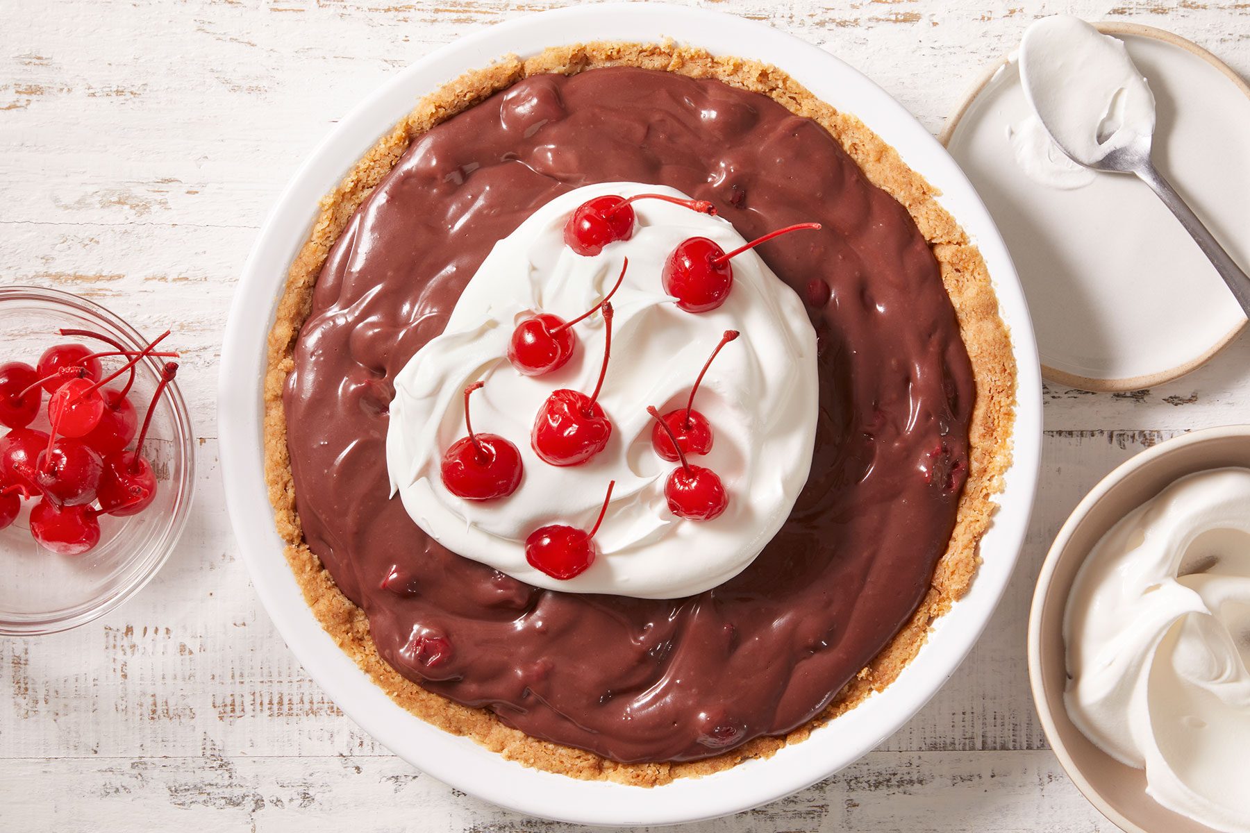 Chocolate Cherry Pie with some cherries on top and side in a plate.