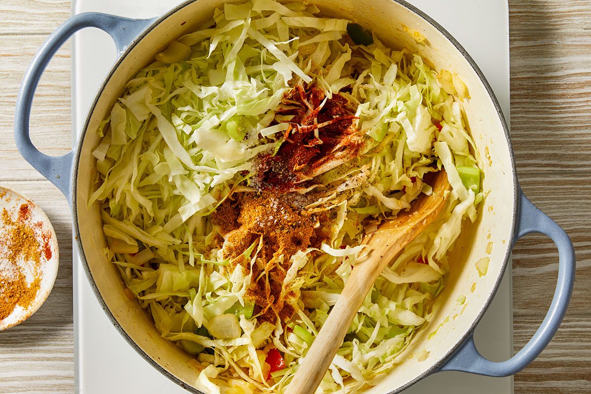 Overhead step-by-step trend food photography of shredded cabbage added to a Dutch oven and seasoned for Dirty Cabbage.