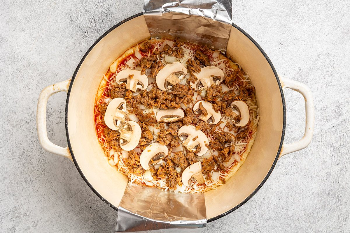 place dough on sling and gently lower dough into pan.