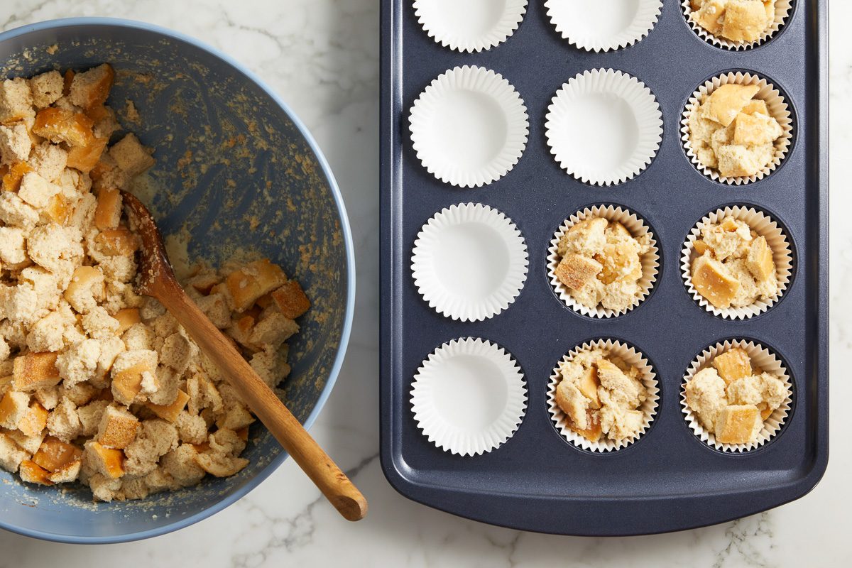 dividing muffin mixture evenly in muffin cups