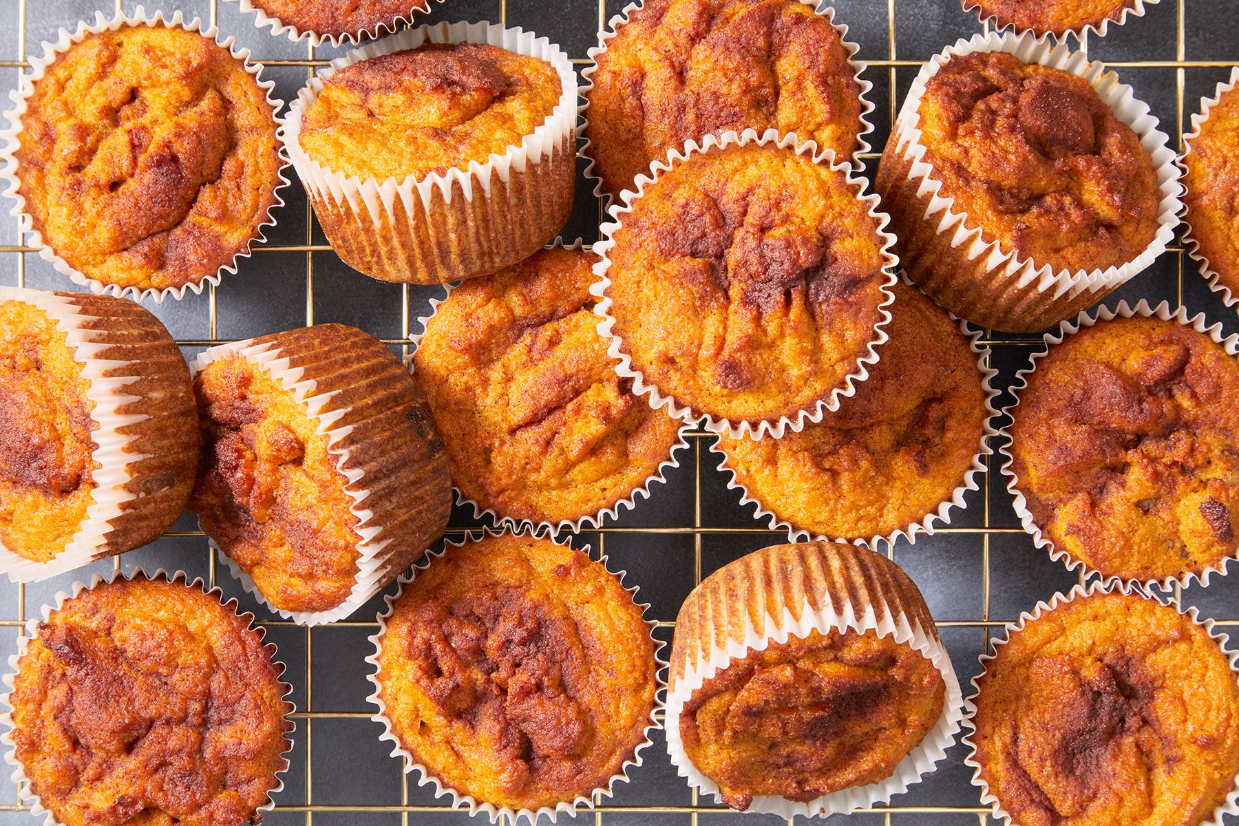 Baked Keto Pumpkin Muffins cooling on a wire rack.