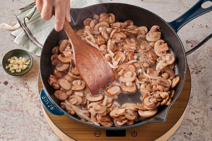 Sauté mushrooms in butter in a large skillet with chopped onions. Stirring with a wooden ladle.