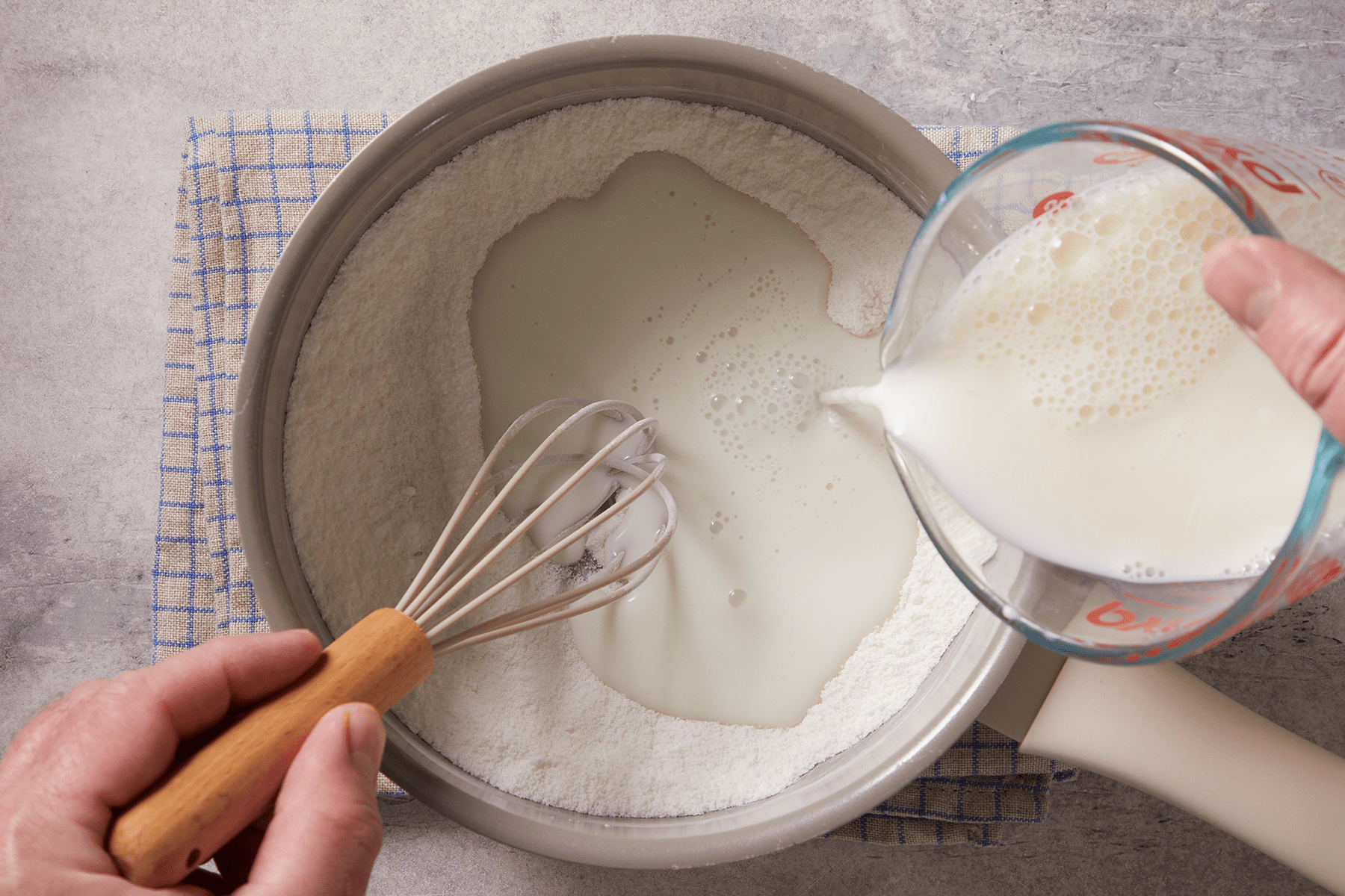 Adding milk to starch, sugar and salt in a pan