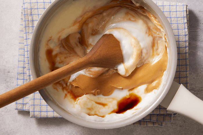 stirring peanut butter to a mixture of pudding