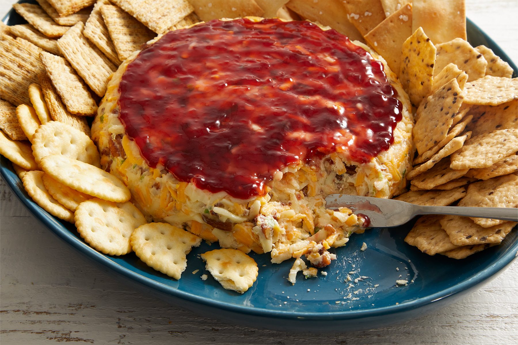 Raspberry Cheese Spread with snacks in a plate