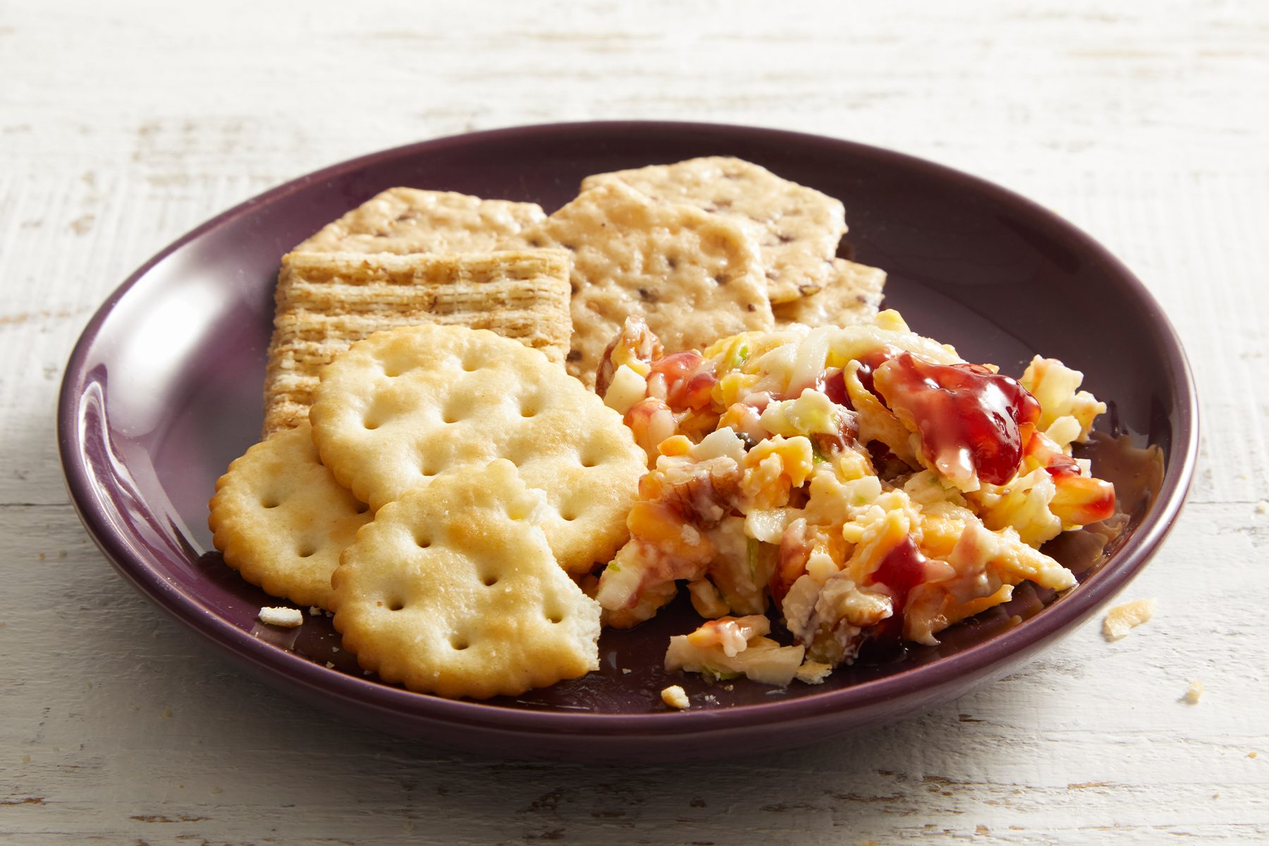 Raspberry Cheese Spread along with snacks kept inside a plate