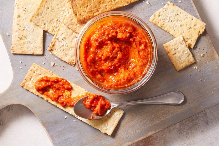Overhead shot of Roasted Red Pepper Spread served with crackers