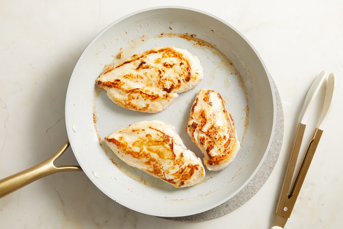 browned chicken in a skillet