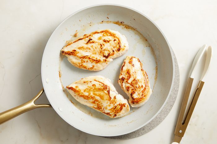 browned chicken in a skillet
