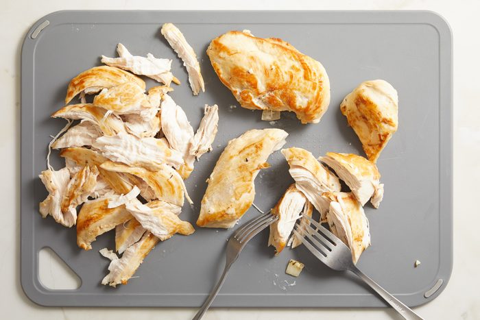 shredded chicken on. cutting board