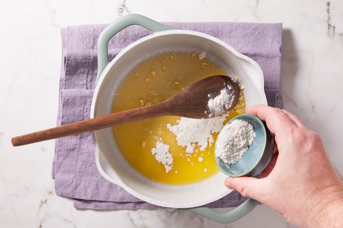 adding flour to melted butter