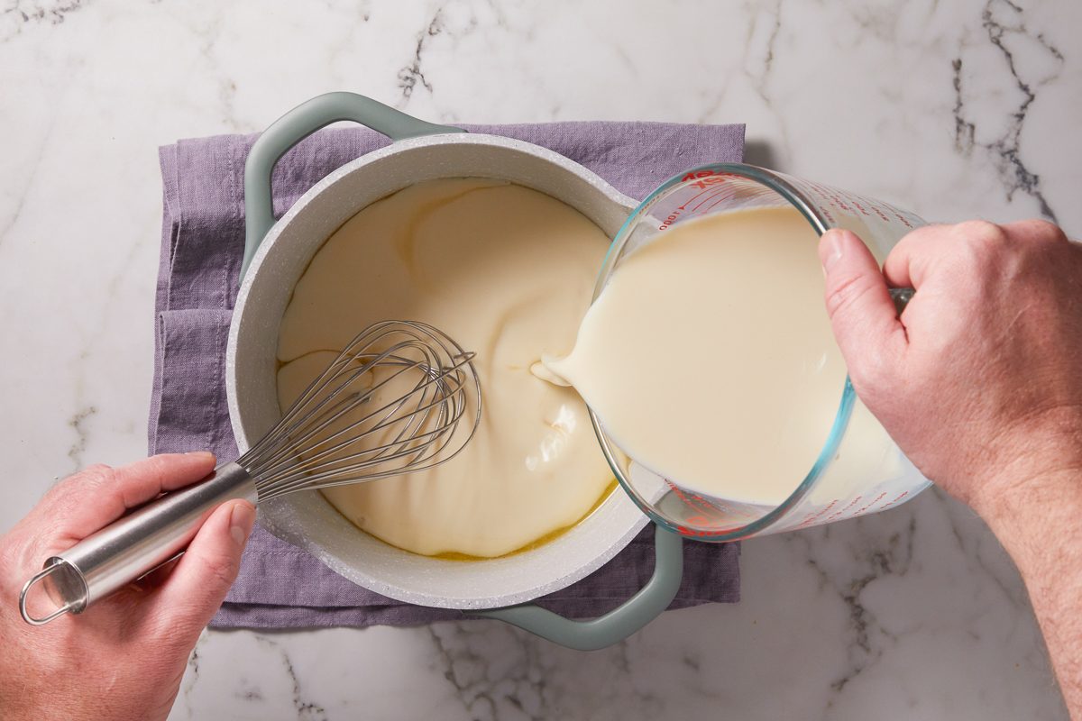 soy milk being added to sauce mixture