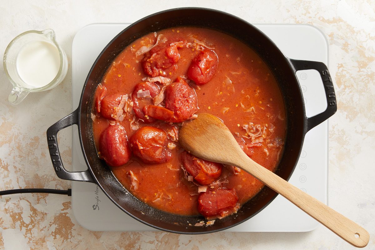 cooking tomatoes in tomato paste in a large skillet