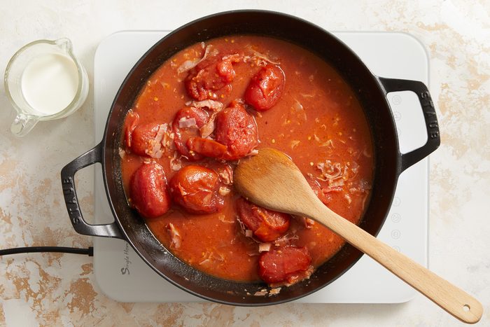 cooking tomatoes in tomato paste in a large skillet