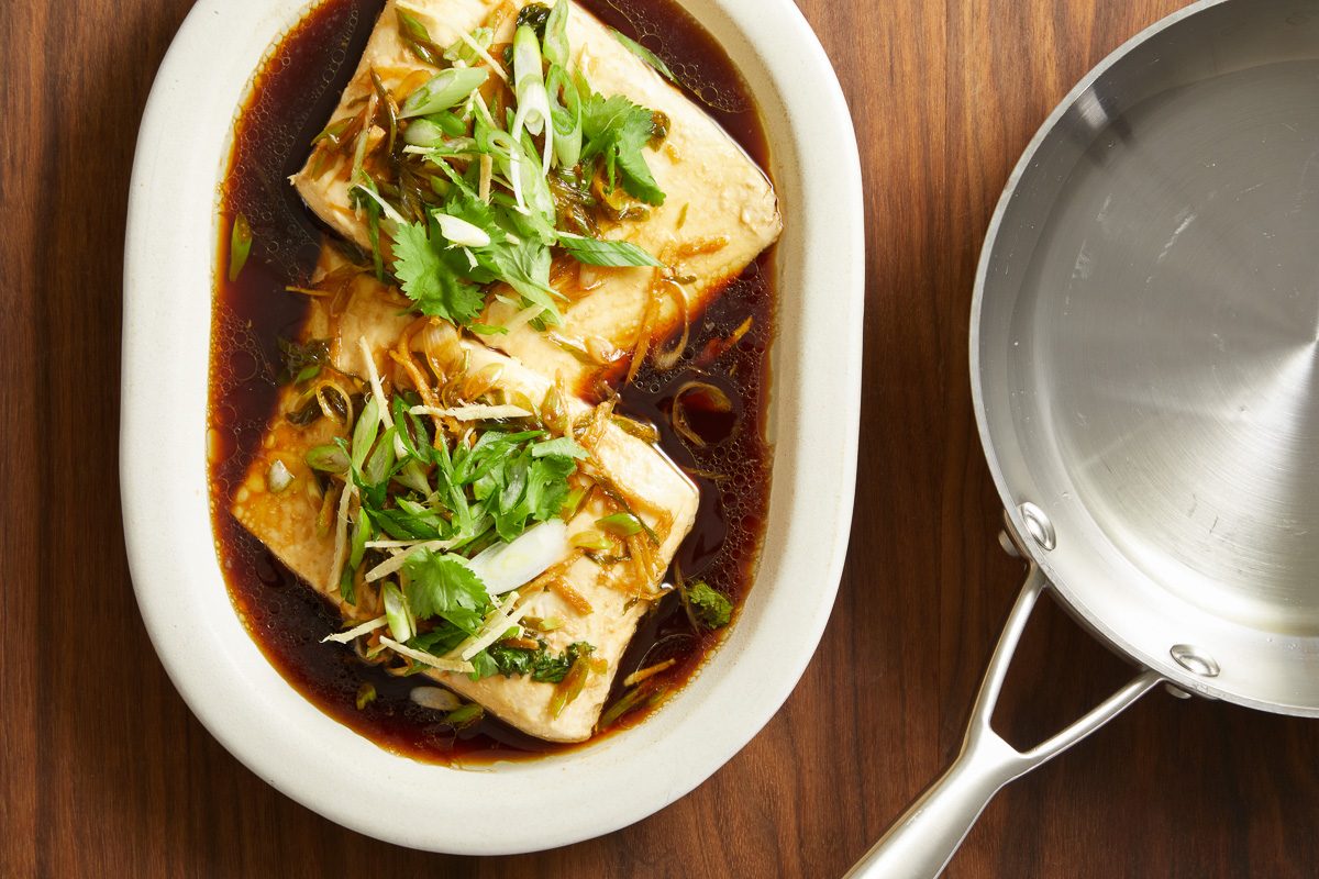 canola oil in a small skillet next to steamed fish
