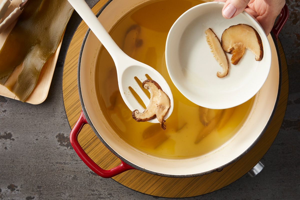 placing water, dried shiitakes and kombu in a large pot