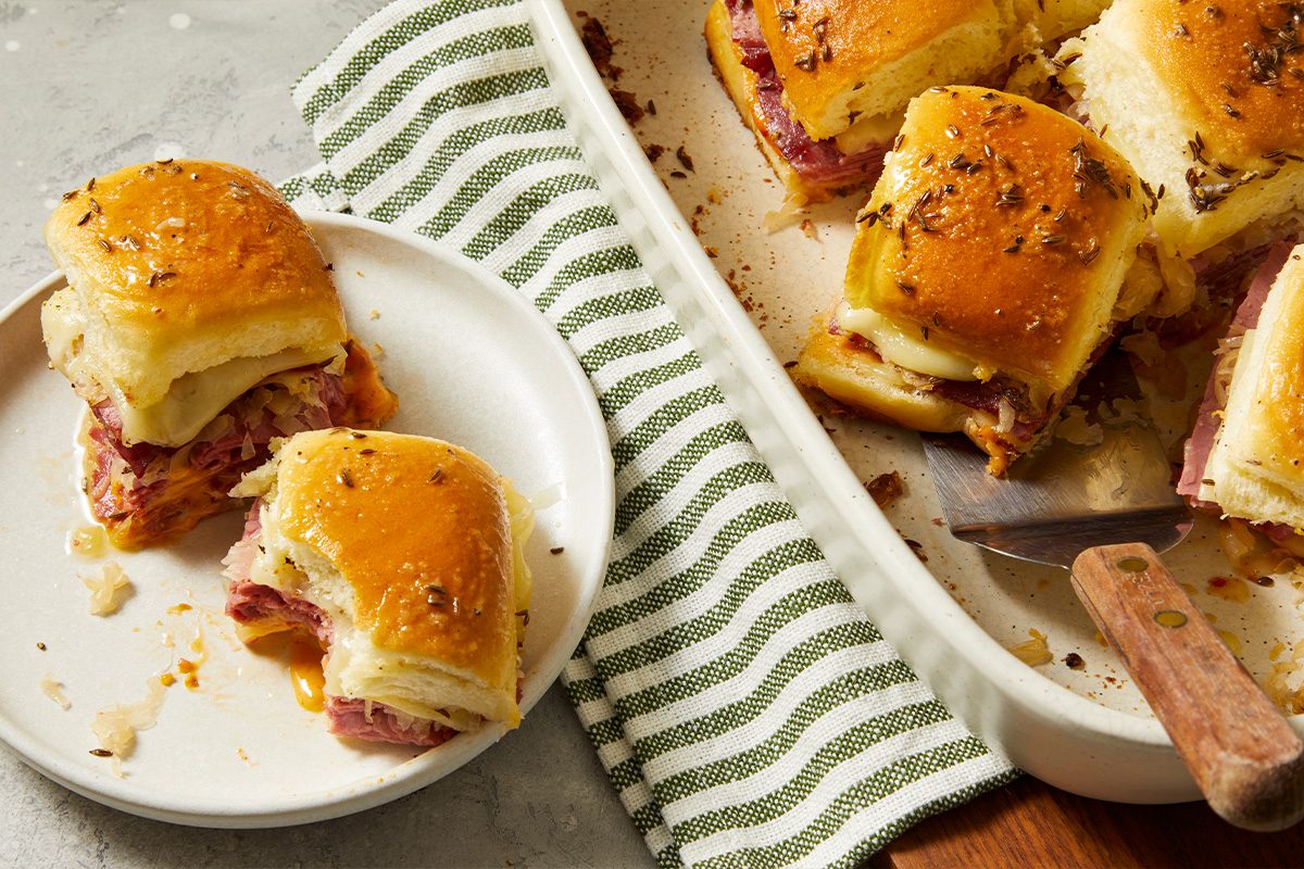 Overhead food photography showing Reuben sliders plated and served, highlighting individual portions ready to eat.