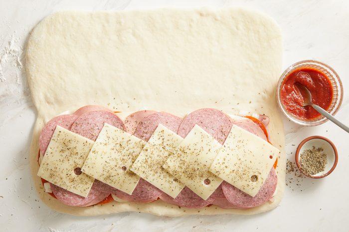 dried basil, oregano, garlic powder and pepper sprinkled over sliced mozzarella, bologna, salami and Swiss cheese